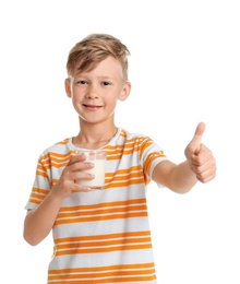 Adorable little boy with glass of milk on white background