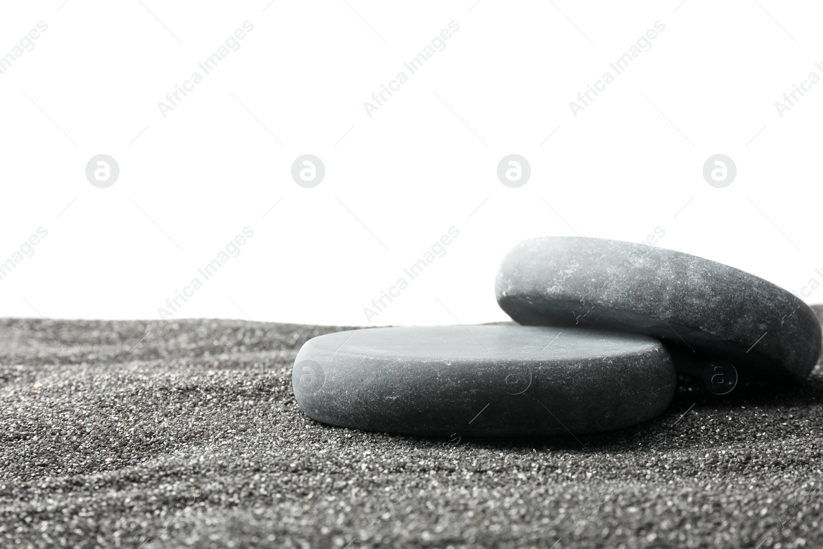 Photo of Presentation of product. Stone podiums on black sand against white background