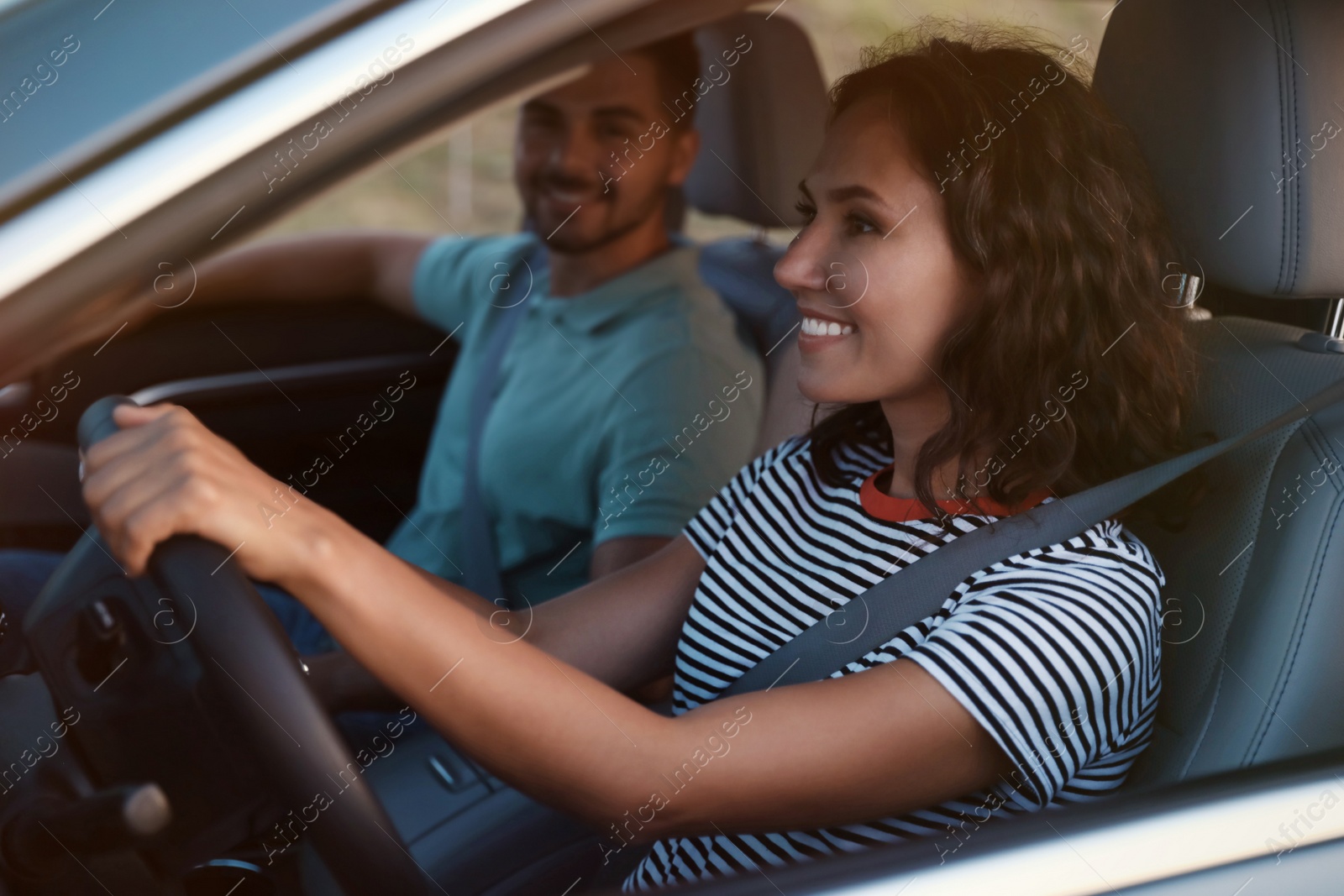 Photo of Happy young couple traveling by family car in evening