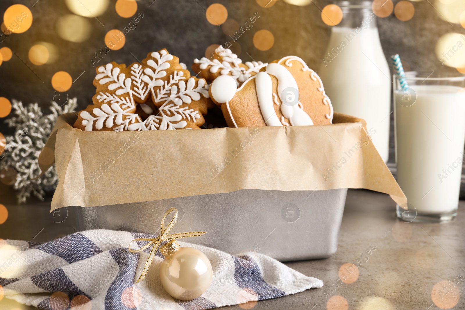 Photo of Decorated Christmas cookies in box on grey table