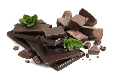 Photo of Tasty dark chocolate pieces with mint on white background