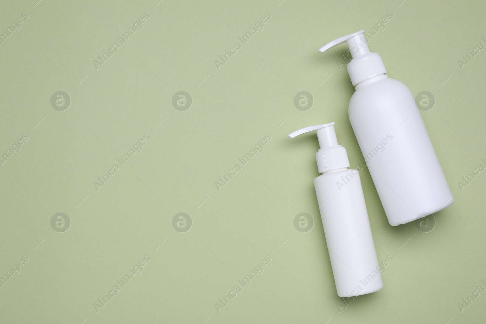 Photo of Different cleansers on olive background, flat lay with space for text. Cosmetic product