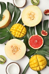 Flat lay composition with melon and other fruits on white background