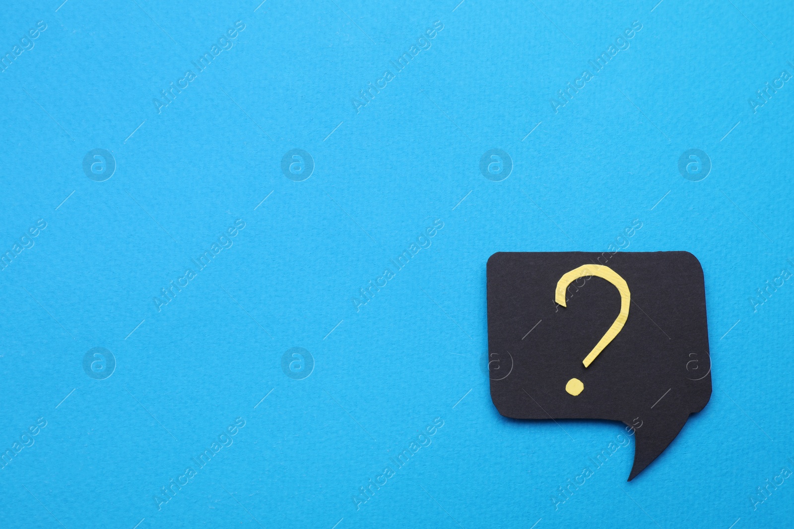 Photo of Paper speech bubble with question mark on light blue background, top view. Space for text