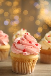 Tasty sweet cupcake on wooden table, closeup. Happy Valentine's Day