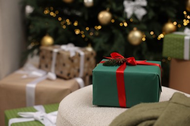 Photo of Gift box in room with Christmas tree, space for text