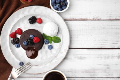 Photo of Delicious chocolate fondant served with fresh berries and ice cream on white wooden table, flat lay. Space for text