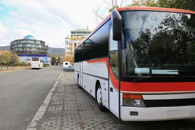 Photo of Modern bus on city street, space for text. Public transport