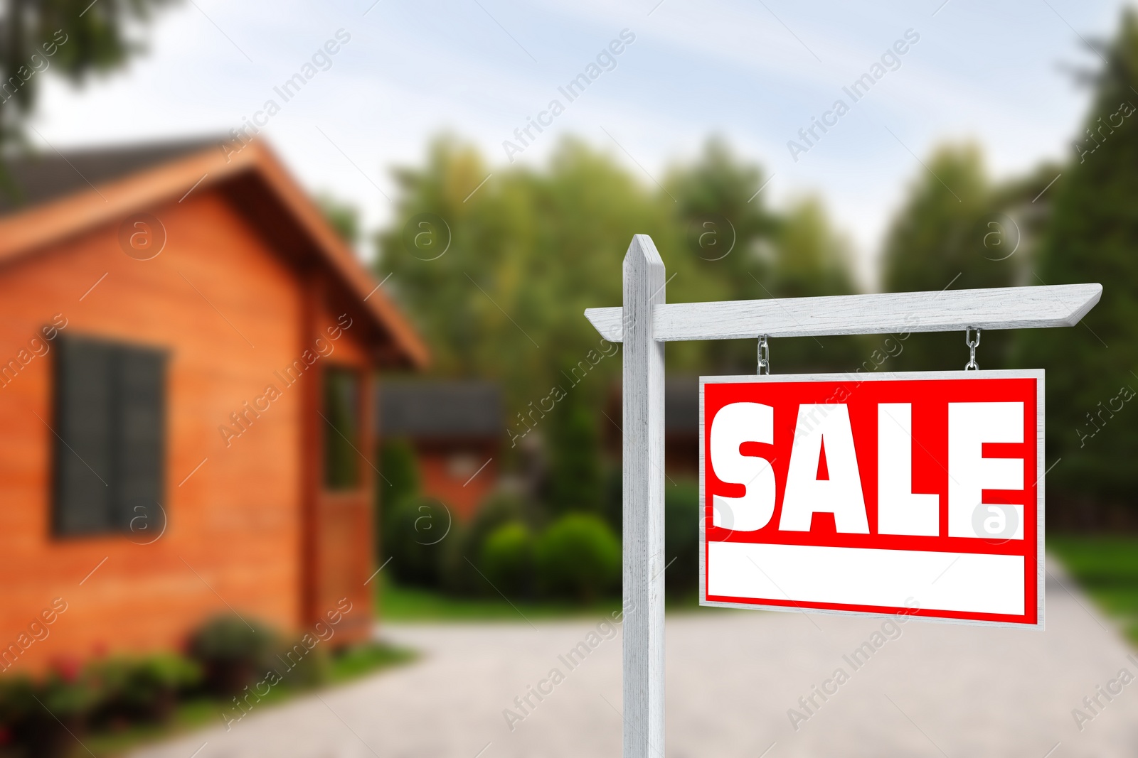 Image of Sale sign near beautiful house outdoors. Red signboard with word