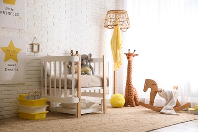 Photo of Baby room interior with toys and stylish furniture