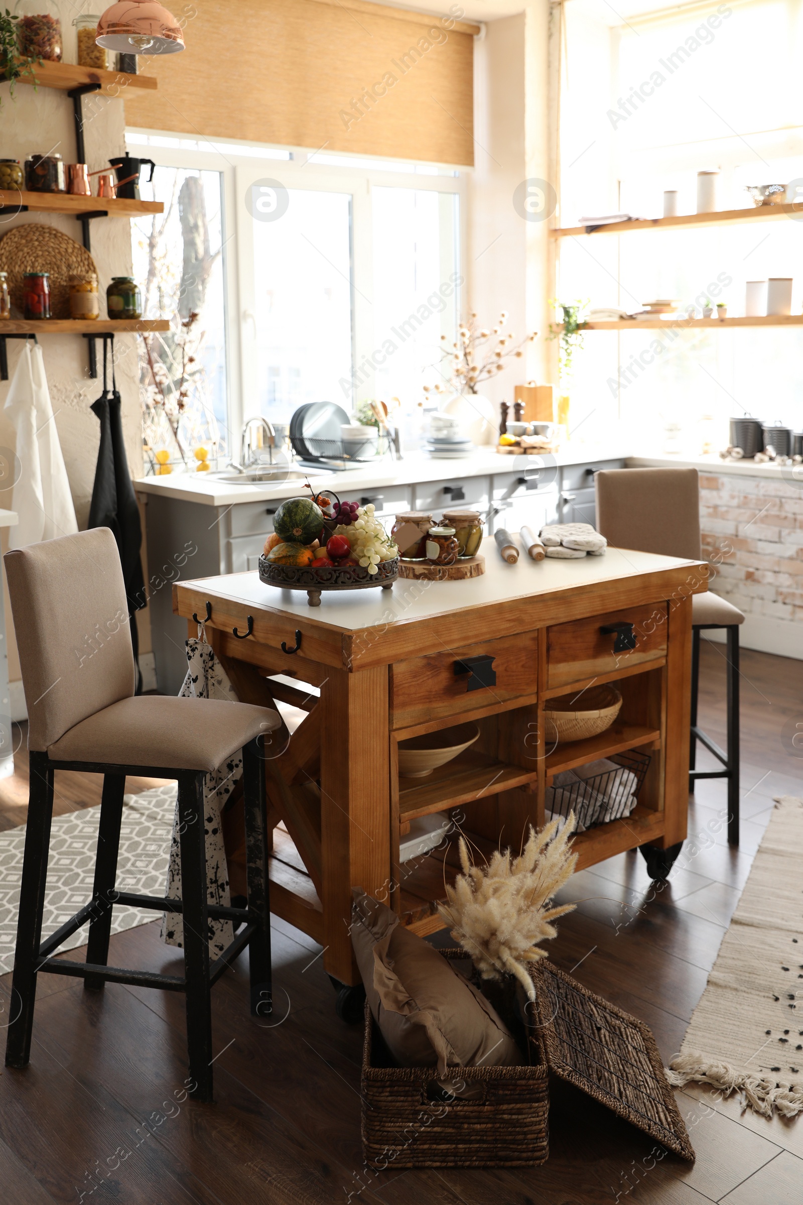 Photo of Stylish kitchen interior with wooden table and chairs