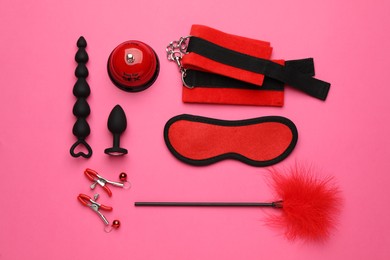 Sex toys and accessories on pink background, flat lay