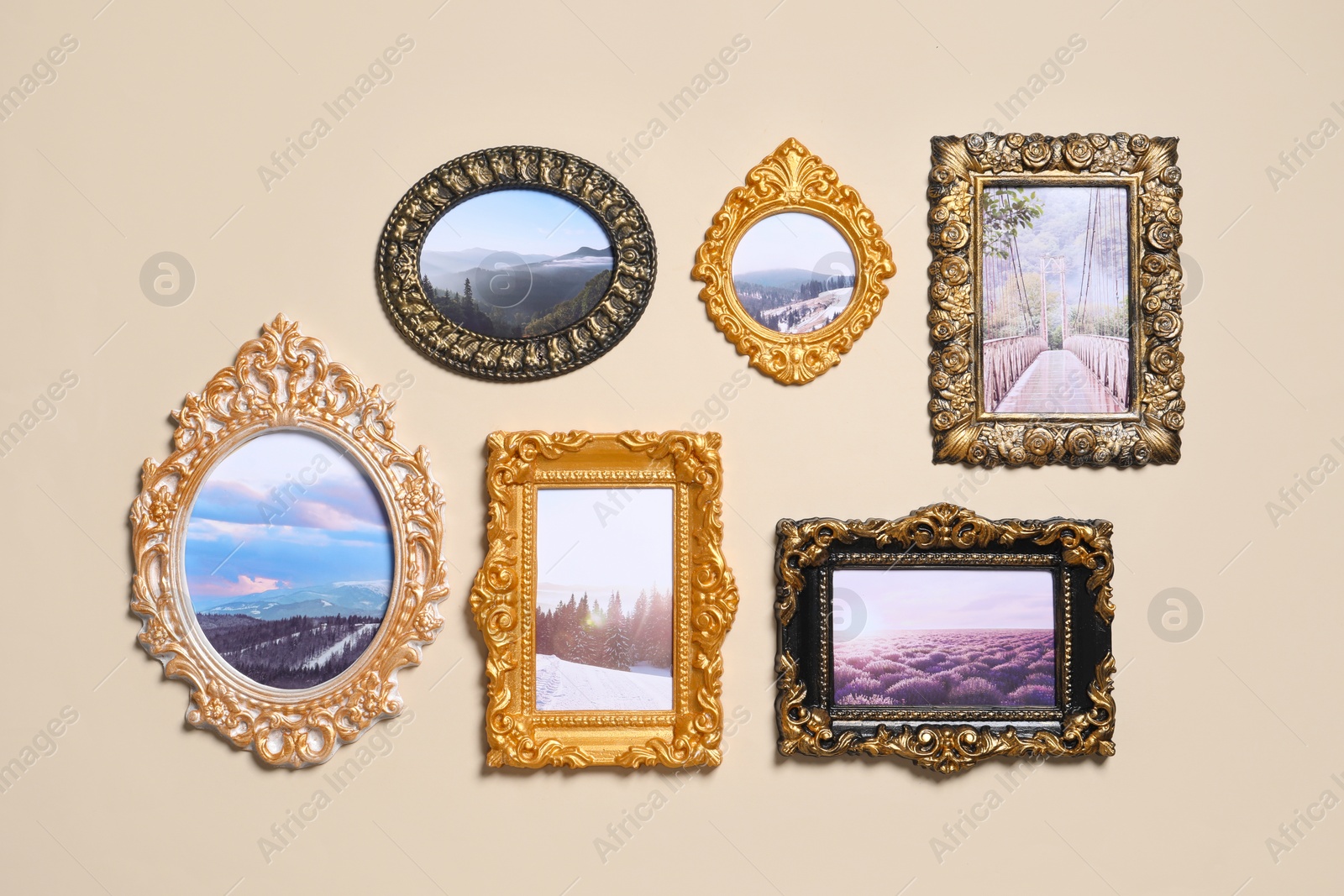Photo of Vintage frames with photos of beautiful landscapes hanging on beige wall