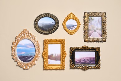 Photo of Vintage frames with photos of beautiful landscapes hanging on beige wall