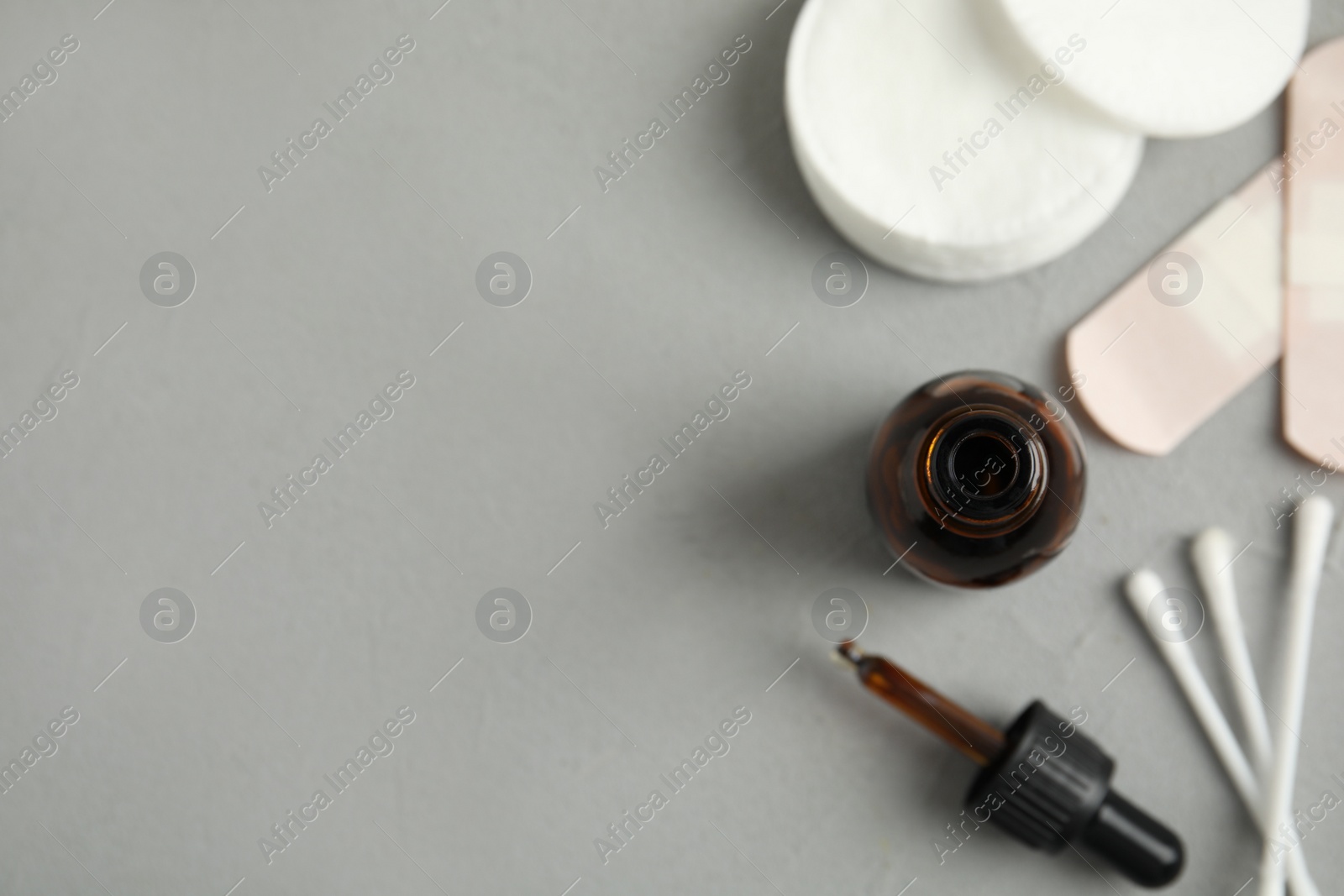 Photo of Flat lay composition with bottle of medical iodine on grey table. Space for text