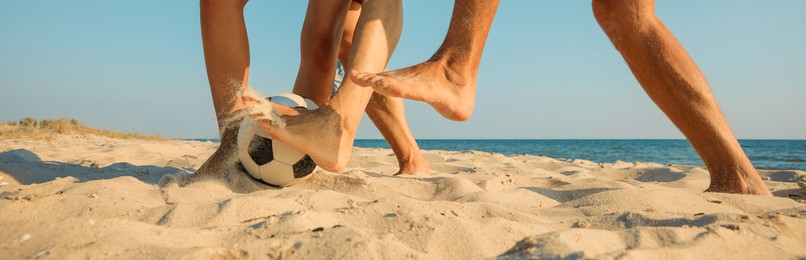 Image of Group of friends playing football on sandy beach, closeup. Banner design