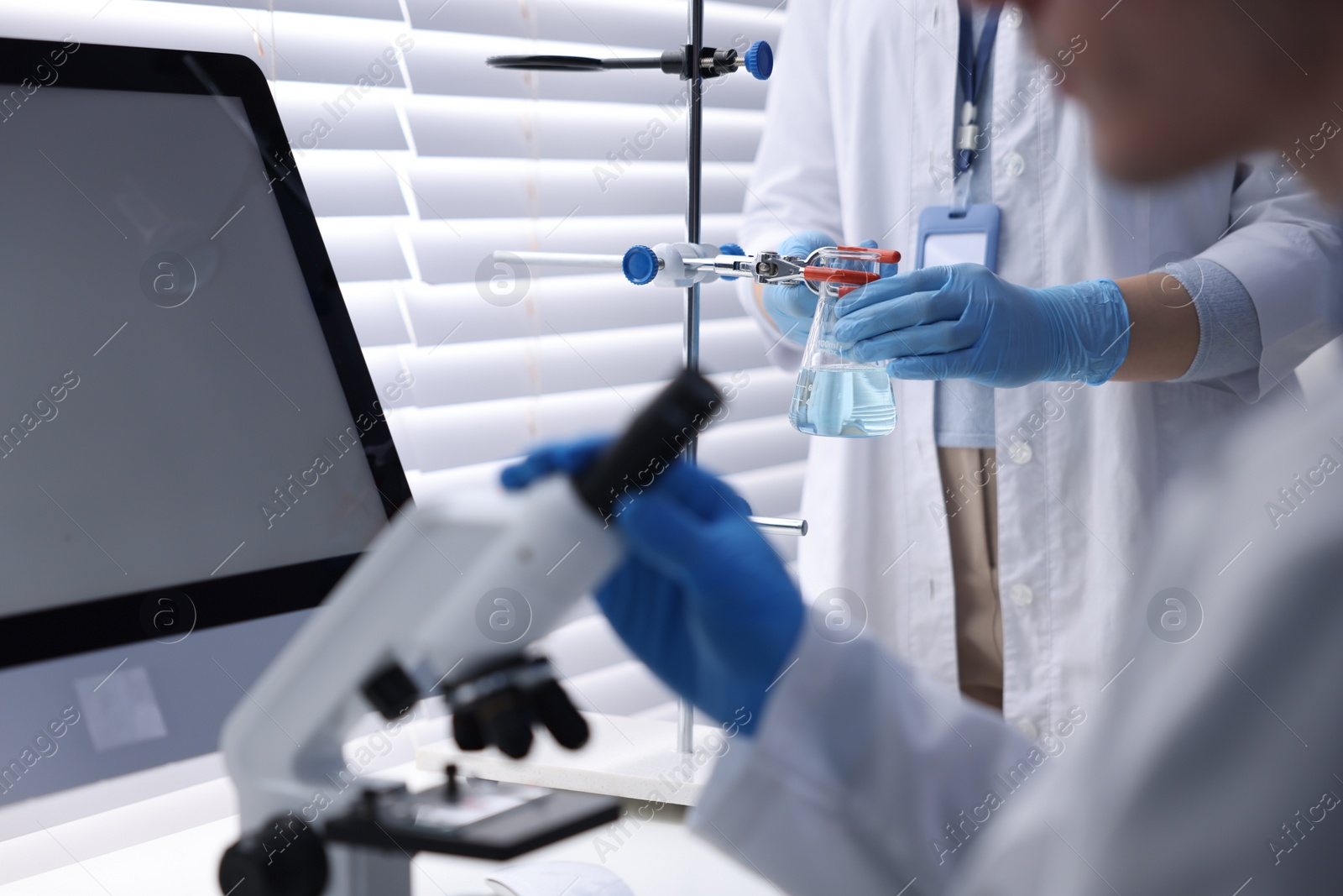 Photo of Scientists working with samples in laboratory, closeup. Medical research