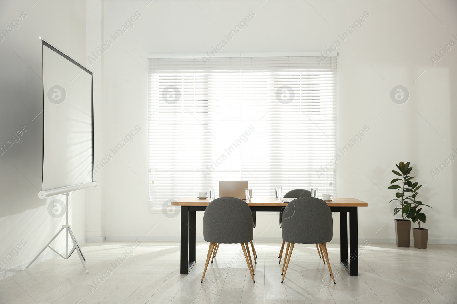 Photo of Conference room interior with wooden table and video projection screen