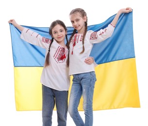 Happy girls in national clothes with flag of Ukraine on white background