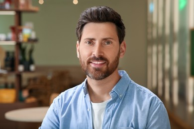 Photo of Portrait of handsome stylish man in cafe