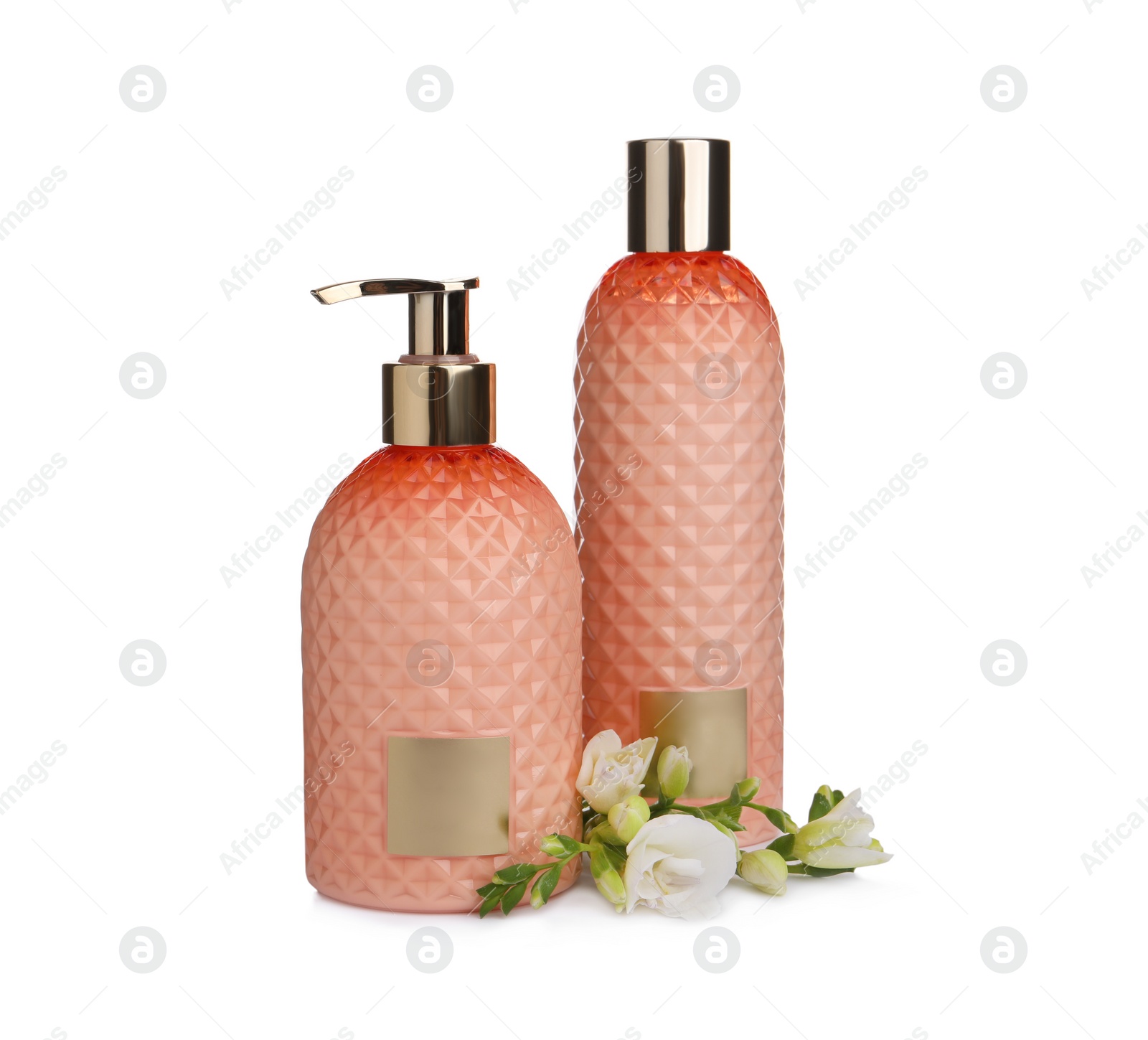 Photo of Stylish bottles with cosmetic products and flowers on white background