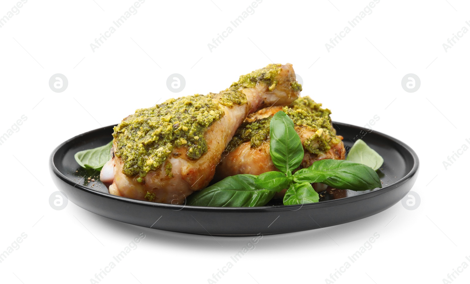 Photo of Delicious fried chicken drumsticks with pesto sauce and basil isolated on white