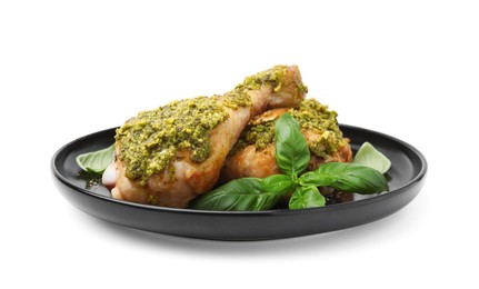 Delicious fried chicken drumsticks with pesto sauce and basil isolated on white