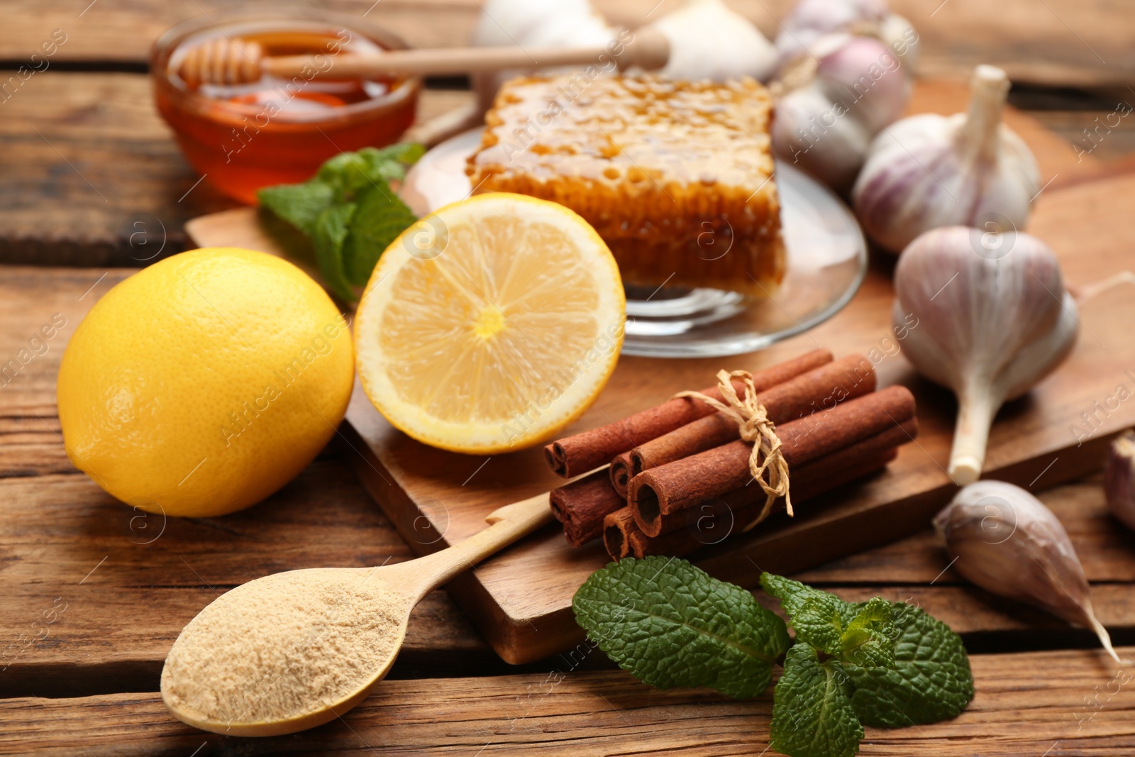 Photo of Different fresh products on wooden table, closeup. Natural antibiotics