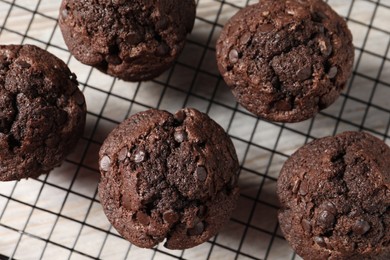 Delicious chocolate muffins on table, top view