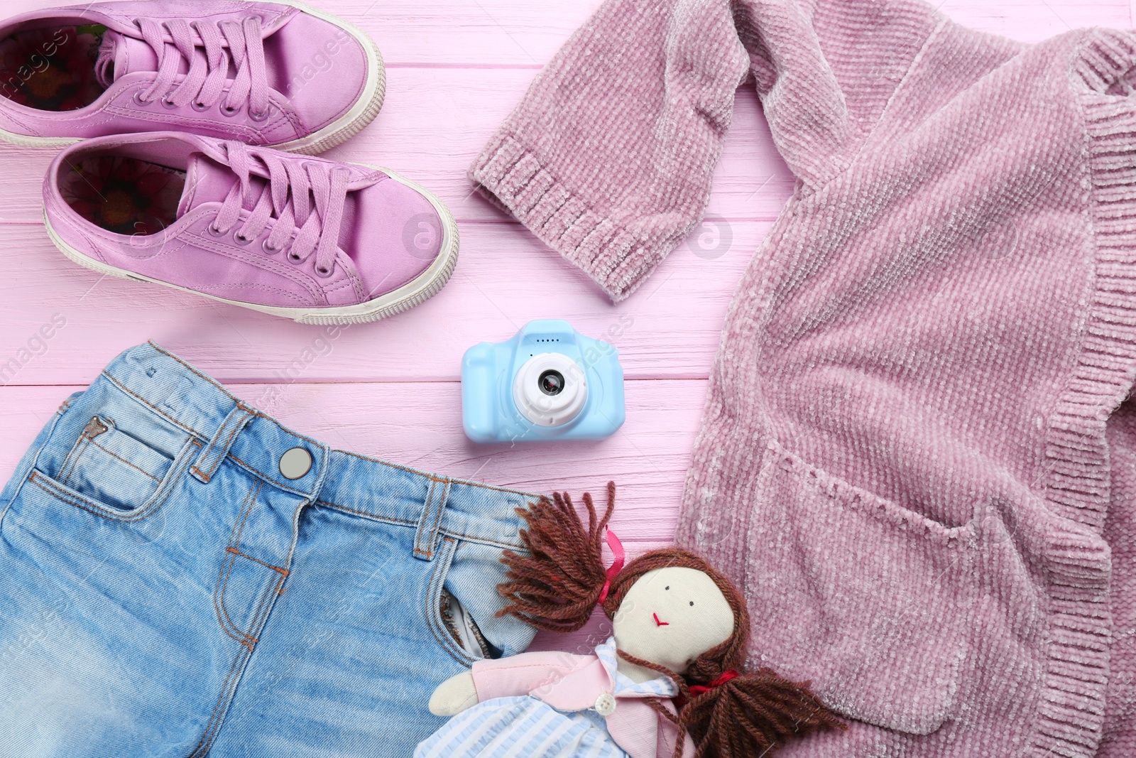 Photo of Flat lay composition with little photographer's toy camera on pink wooden background