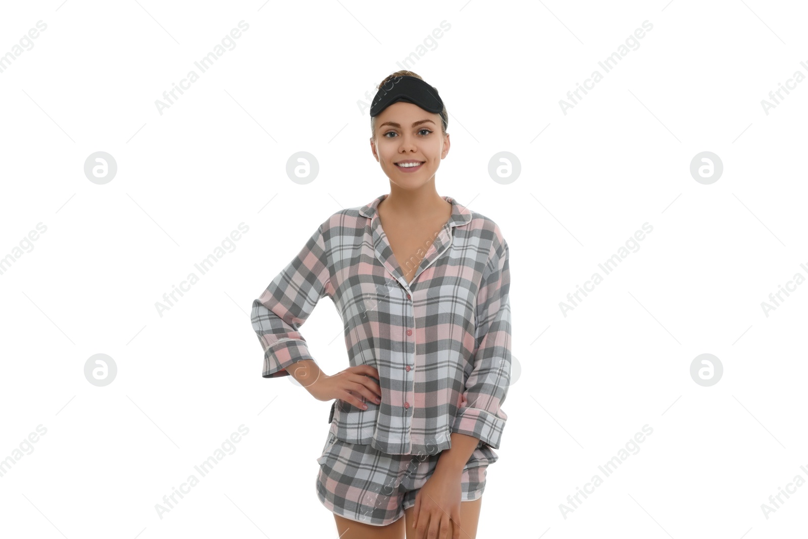 Photo of Beautiful woman wearing pajamas and sleeping mask on white background. Bedtime