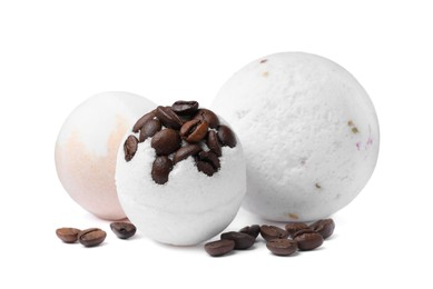 Photo of Fragrant bath bombs and coffee beans on white background