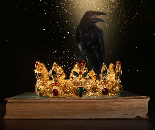 Image of Fantasy world. Black crow lit by magic light sitting on golden crown 
