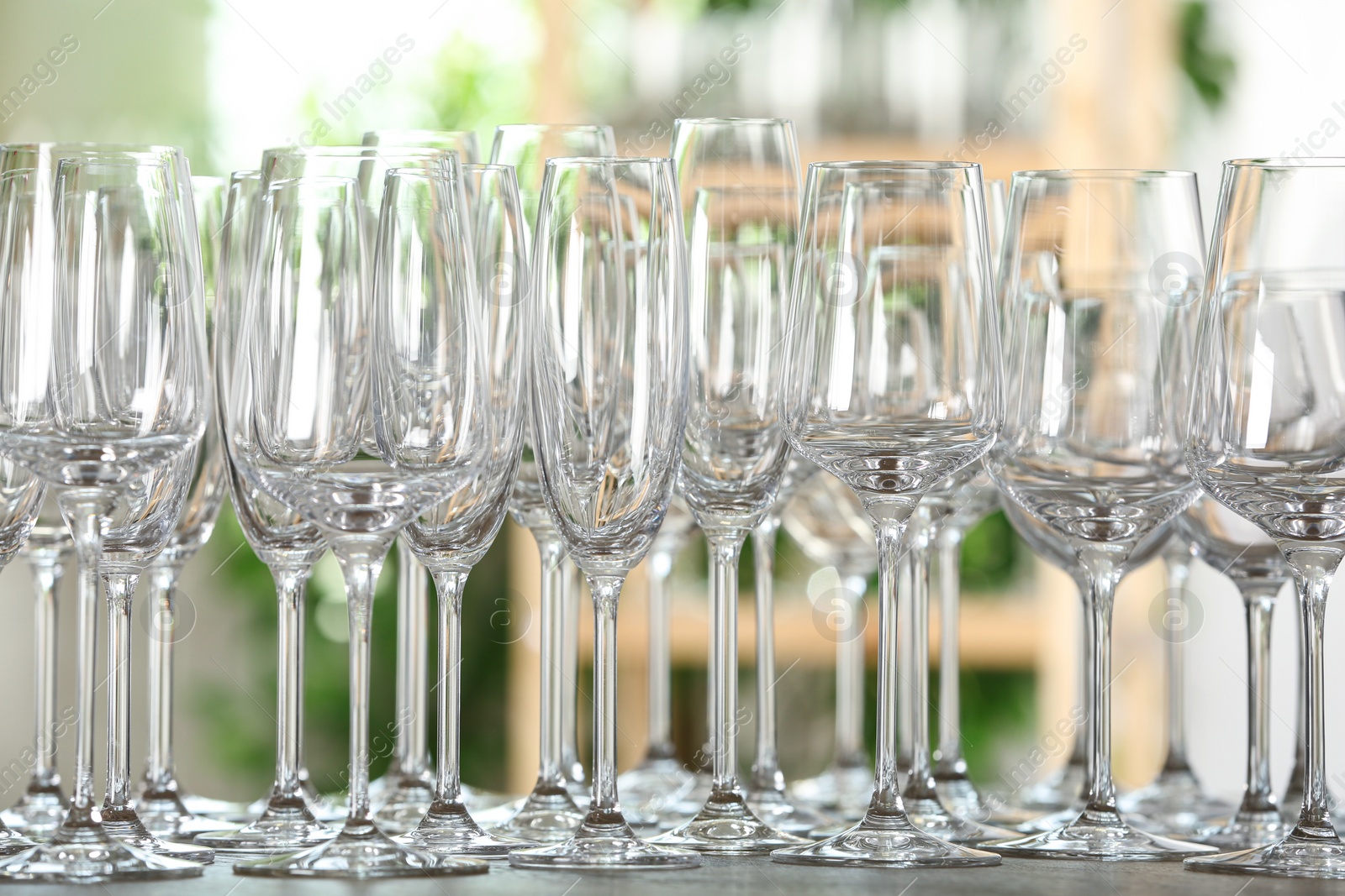 Photo of Empty glasses on wooden table against blurred background