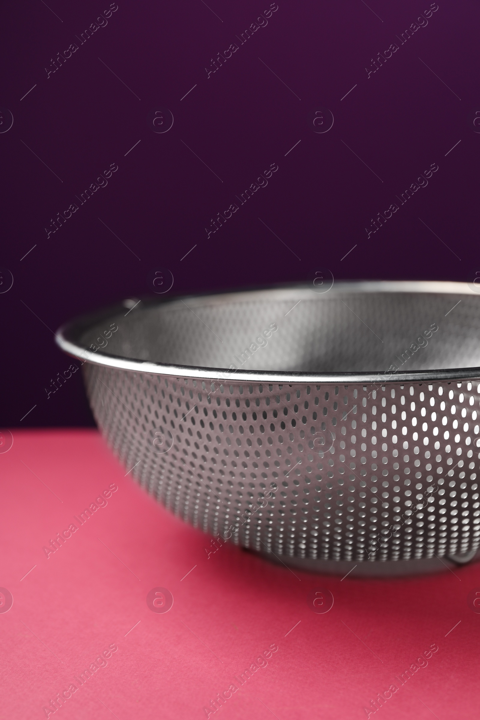 Photo of One clean empty colander on color background, closeup