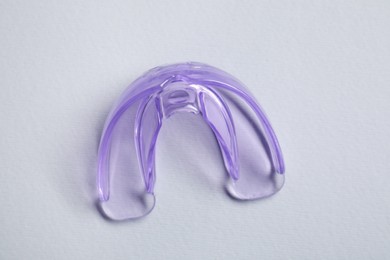 Photo of Dental mouth guard on grey background, top view. Bite correction
