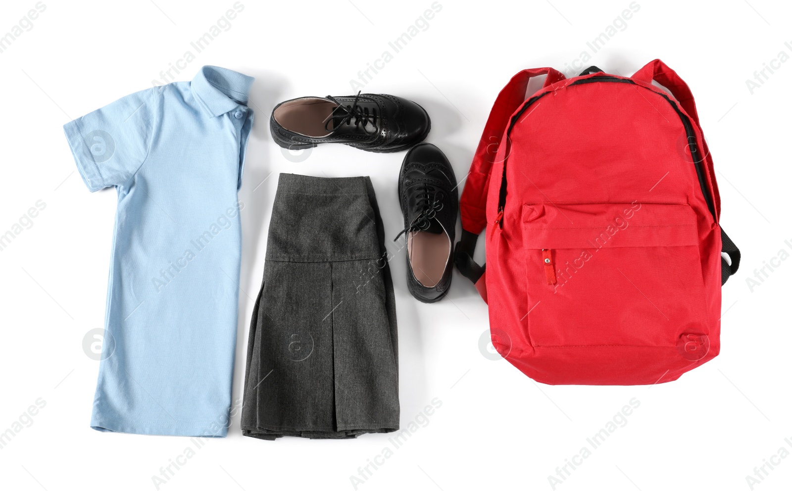 Photo of Stylish school uniform for girl and backpack on white background, top view