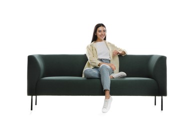 Young woman relaxing on comfortable green sofa against white background