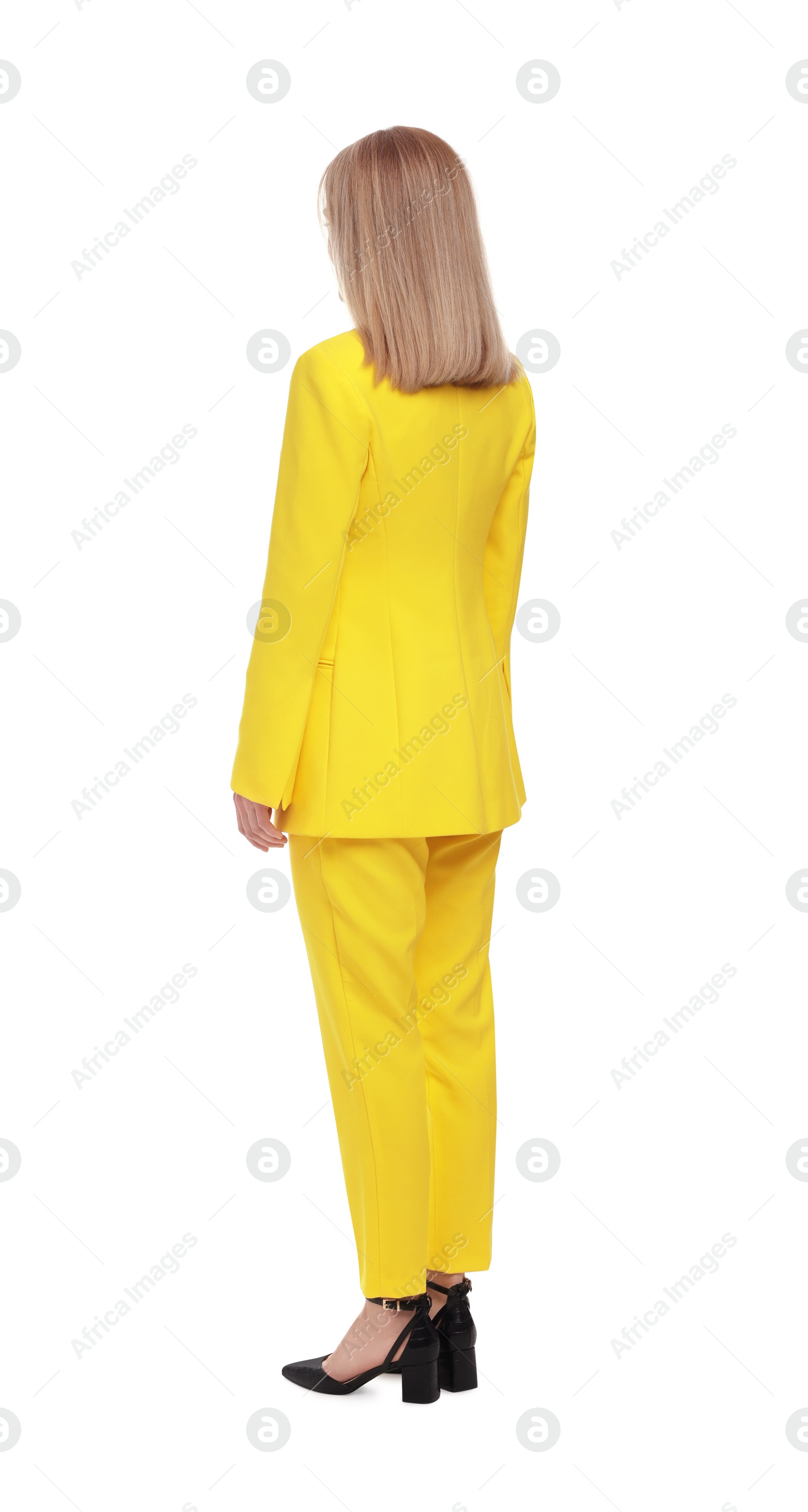 Photo of Businesswoman in suit standing on white background, back view