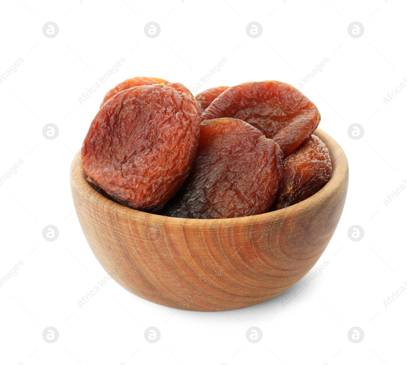 Photo of Wooden bowl with tasty dried apricots isolated on white