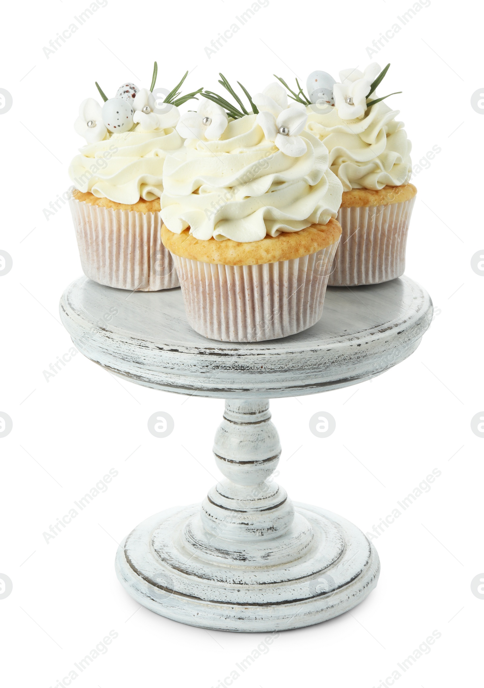 Photo of Tasty Easter cupcakes with vanilla cream isolated on white