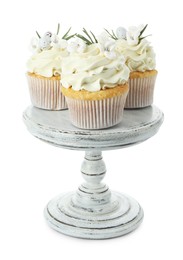 Tasty Easter cupcakes with vanilla cream isolated on white