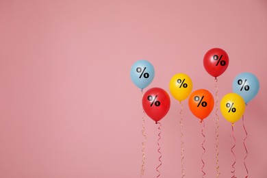 Image of Discount offer. Balloons with percent sign on pink background, space for text