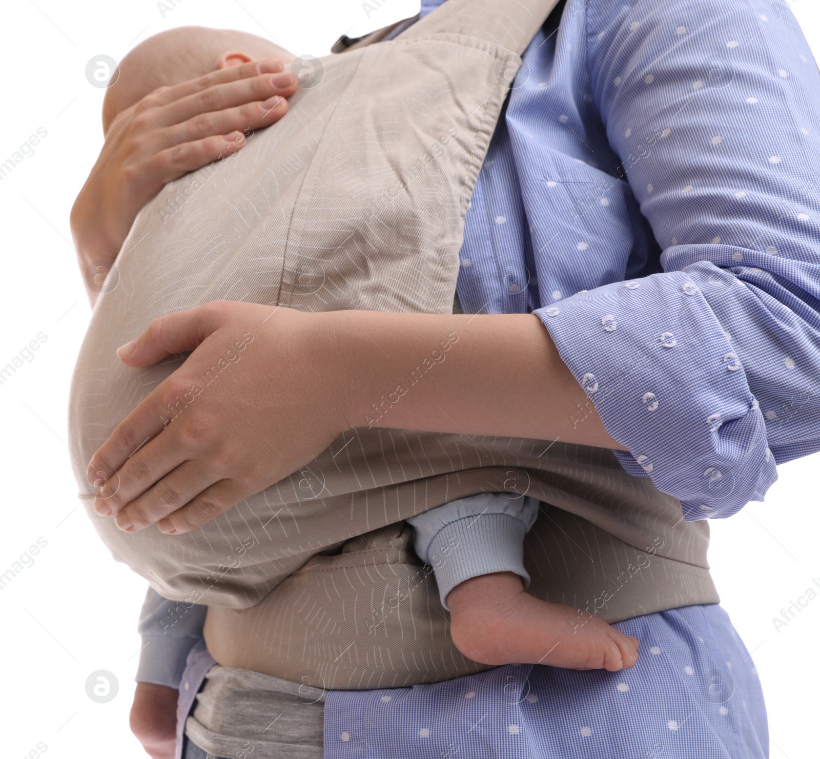 Photo of Mother holding her child in baby carrier on white background, closeup