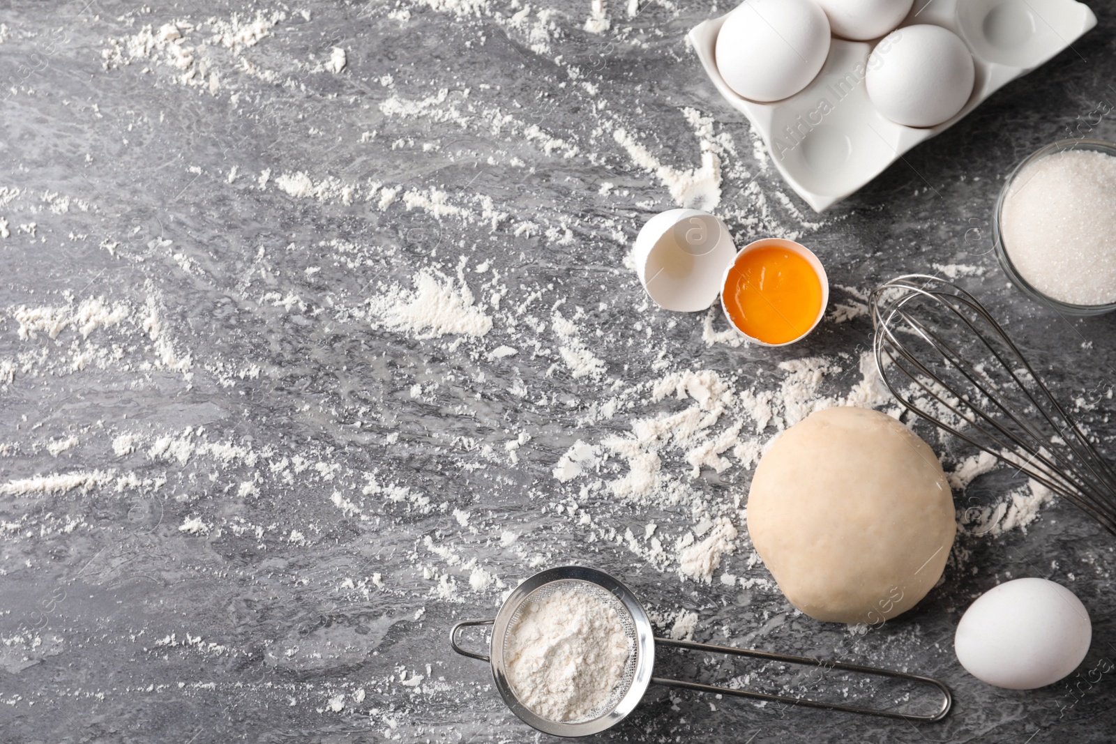 Photo of Flat lay composition with dough on grey table, space for text. Cooking pastries