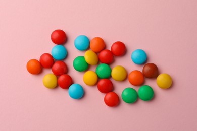 Photo of Tasty colorful candies on pink background, flat lay