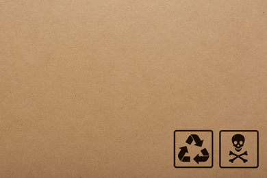 Cardboard box with packaging symbols as background, closeup