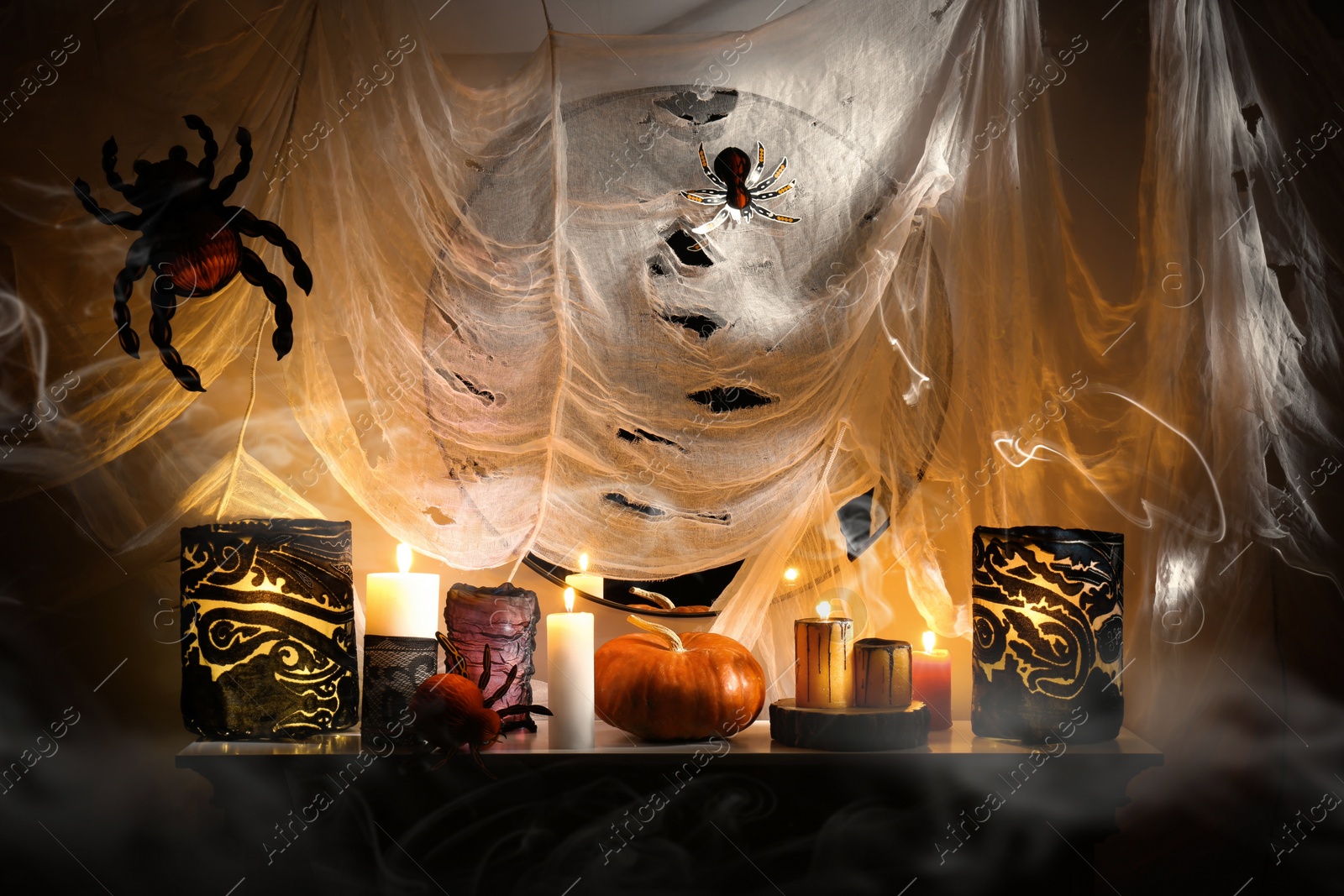 Photo of Different Halloween decor on fireplace indoors. Festive interior