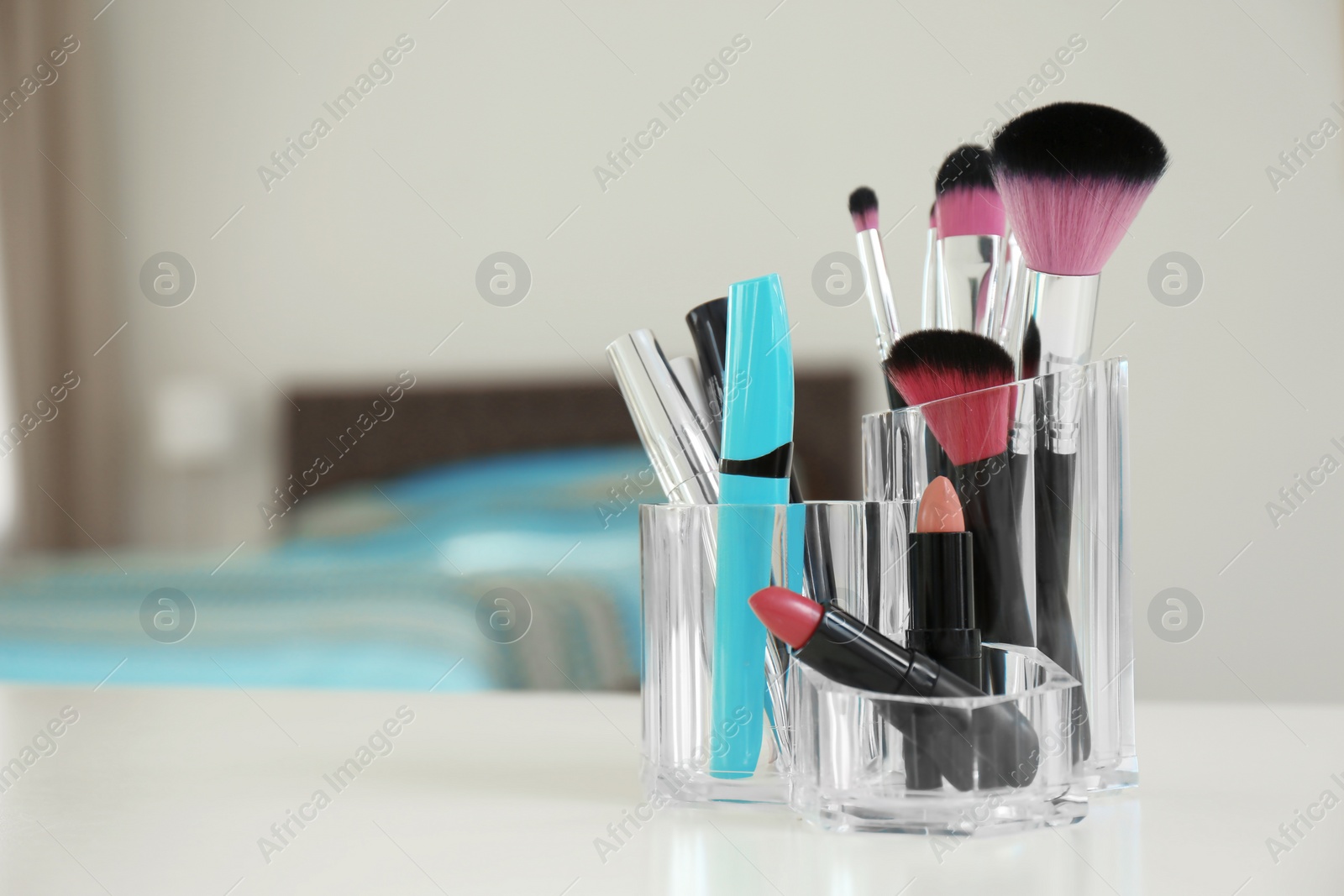 Photo of Organizer with makeup cosmetic products on table indoors. Space for text