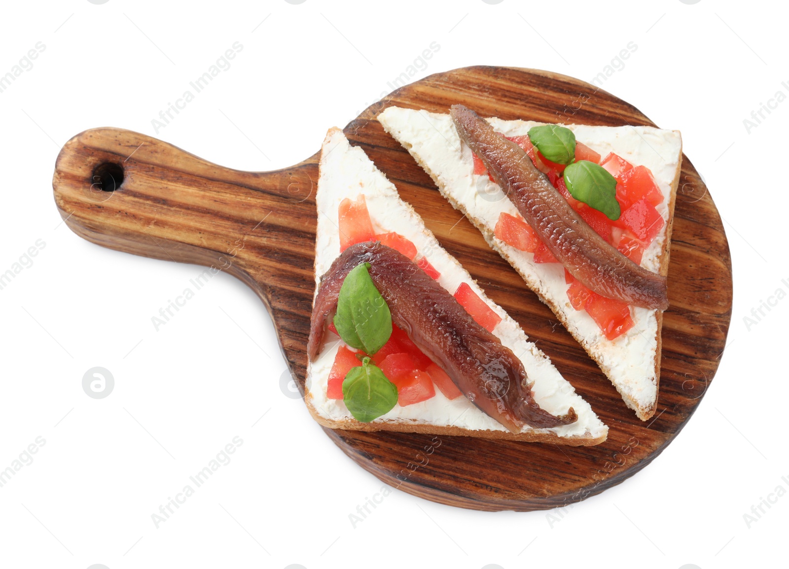 Photo of Delicious sandwiches with cream cheese, anchovies, tomatoes and basil on white background, top view